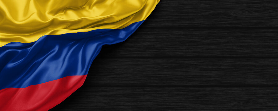 Close Up of Colombia flag on the black wooden background 3D render