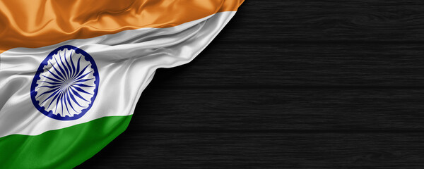 Close Up of India flag on the black wooden background 3D render