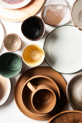 Top view of group of ceramic plate and cup on white background