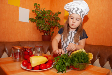 A charming European woman helps her mother in the kitchen for Mother's Day. girl cook canns pomiory in jars in his hands