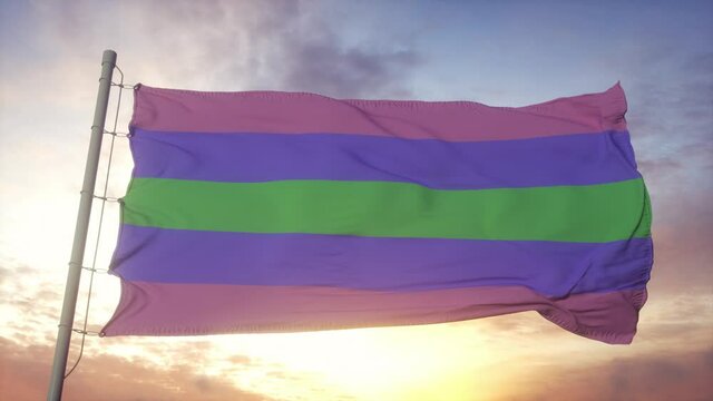 Trigender pride flag waving in the wind, sky and sun background