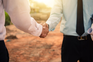 Businessman Shake hand agreement construction real estate project on site