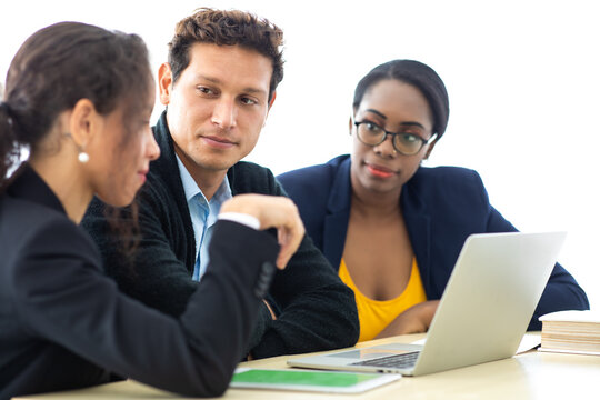Business man manager leader in meeting with two woman analyzing ducuments on laptop computer in home office.