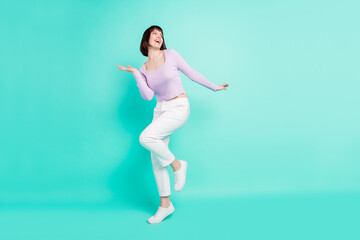 Fototapeta na wymiar Full length body size photo woman happy overjoyed dancing at party looking copyspace isolated vivid teal color background