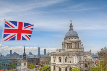 London, England - Sep. 7, 2021 - A Union Jack flag flies in the wind with a view of St Paul's Cathedral in the background.