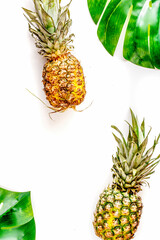 summer dessert with pineapples and leaves on white background top view mock up