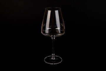Empty transparent wine glass on the black background