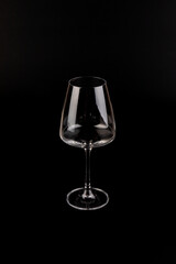 Empty transparent wine glass on the black background