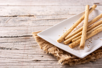 Breadstick grissini snack on rustic wooden table.Copy space