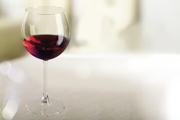 Red wine in an elegant glass on the desk