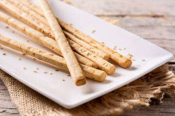 Breadstick grissini snack on rustic wooden table	