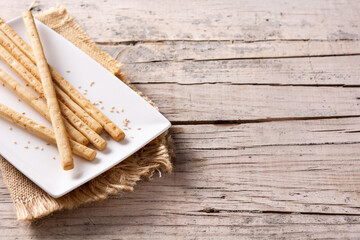 Breadstick grissini snack on rustic wooden table.Copy space