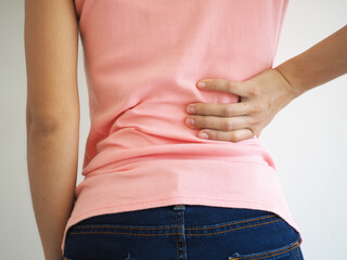 Asian woman suffering from back pain. health care concept. closeup photo, blurred. - obrazy, fototapety, plakaty