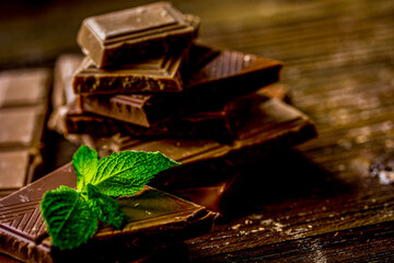 black and milk chocolate bars dark wooden table background