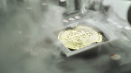 A gold Bitcoin coin with glare and reflection installed instead of a central processor in the...