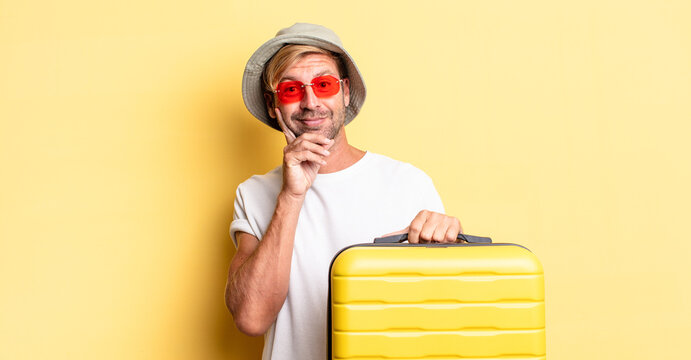 Blond Adult Man Smiling Happily And Daydreaming Or Doubting. Traveler Concept