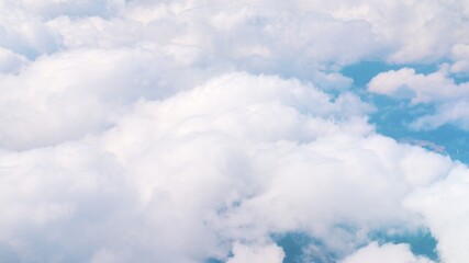Aerial view of breathtaking fluffy clouds as white as snow in the blue sky during the daytime shot over Spain. Cloudscape. Dreamy Background. 