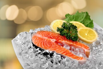 Fresh raw fish Fillets on a plate with lemon and parsley.