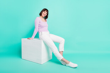 Full length body size photo woman sitting in stylish outfit smiling happy isolated bright turquoise color background