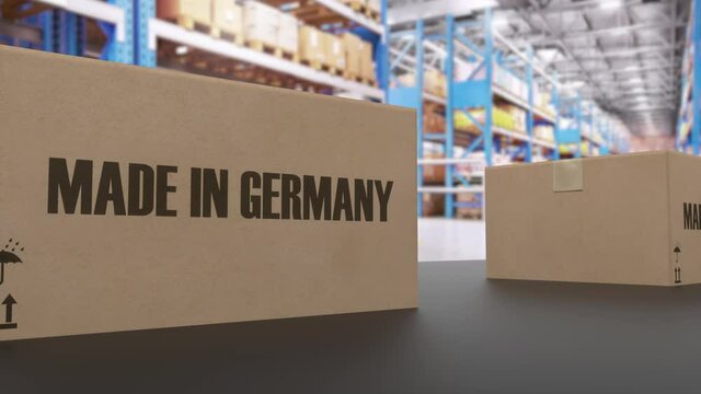 Boxes with MADE IN GERMANY text on conveyor. American goods related loopable 3D animation