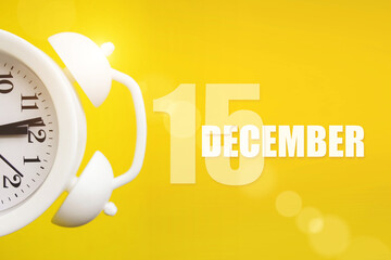 December 15th. Day 15 of month, Calendar date. White alarm clock on yellow background with calendar...
