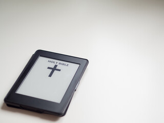 Electronic book with holy bible. Religion and tech concept