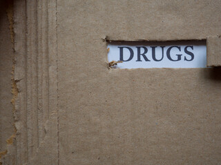 Drugs, word on piece of torn cardboard, Social problematic concept