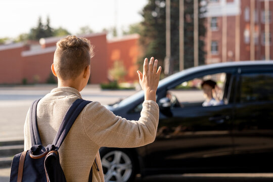 Schoolboy Saying Goodbye To His Mom In The Car Before Going To School In The Morning