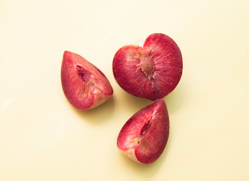 Cutted of Plumcot fruit with red pulp