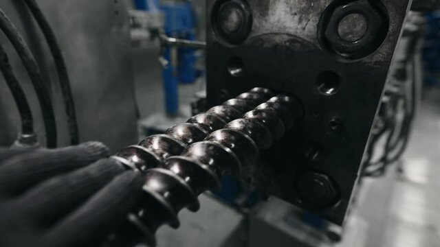 Installation of an automatic line in production. The screws are installed inside. The extruder