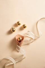 Ice cream waffle cone with ribbon and balls ornament topping. Skin color background