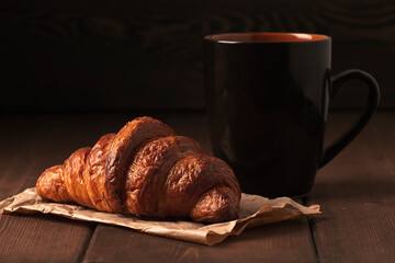 Pastries,Croissants on a brown wooden table, with a cup of coffee, breakfast, no people, rustic style,