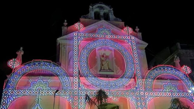 Decorative illuminations in front of the church of Saint Dominic at night for the Patron Saint celebration, Marina di Camerota, Italy 