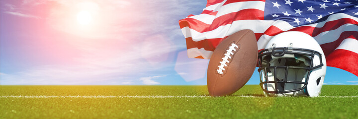 American Football helmet and ball on field with USA flag.