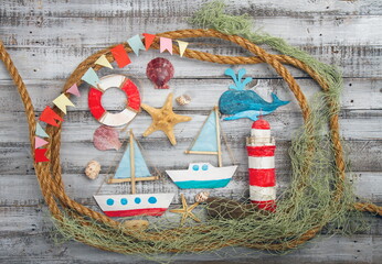 Cute set of kids handcrafted boats, fish, nautical attributes and more on rough vintage wooden...