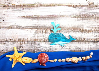 Cute handcrafted whale or sperm whale on rough vintage wooden background top view
