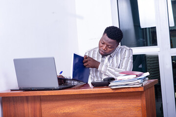 serious adult businessman looking at document in office.