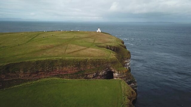 4K Aerial shot of the dramatic coast line of Dunnet Head lighthouse in Scotland. Scotland highlands nature.