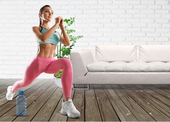 Fototapeta na wymiar Happy young woman doing exercise at home