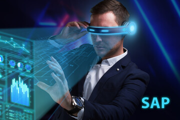 Business, Technology, Internet and network concept. Young businessman working on a virtual screen of the future and sees the inscription: SAP - obrazy, fototapety, plakaty