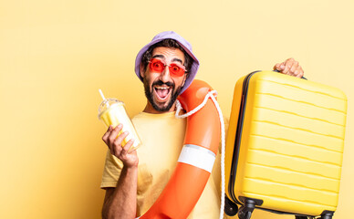 expressive crazy bearded man wearing hat and sunglasses with a suitcase. hollidays concept