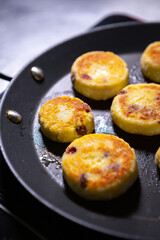 Frying syrniki dish for dinner in slavic restaurant