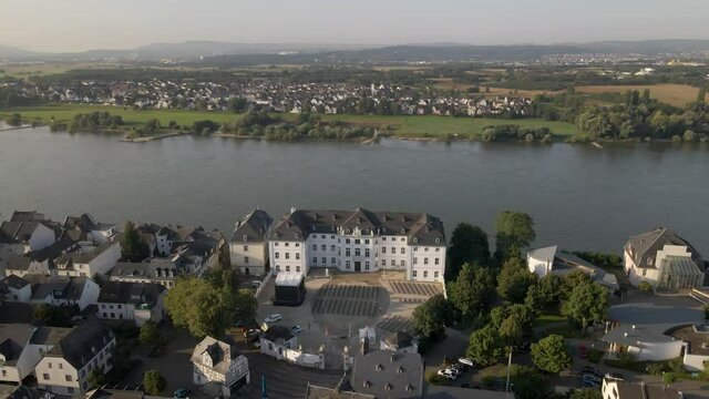 Beautiful aerial of hotel at river bank and revealing small German town