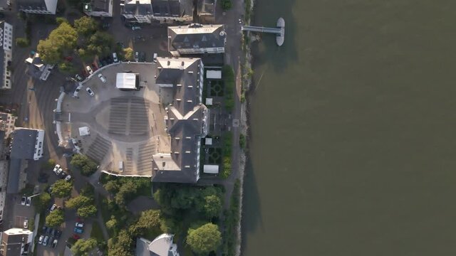 Top down aerial of beautiful hotel at river bank in small German town