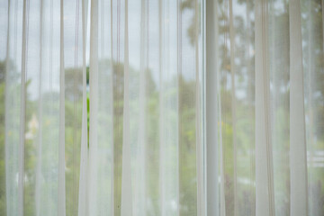 curtains made of white fabric thin and airy for protection from light