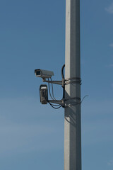 Obraz premium CCTV cameras on a high pillar at the edge of a road bridge.