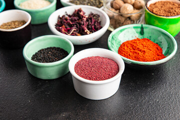 spices and herbs for cooking. Sumac, pepper, paprika, rosemary, khmelisuneli, cloves and more fresh portion ready to eat meal snack on the table copy space food background rustic. top view