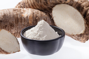 Taro Root of Colocasia esculenta and Organic Taro Flour in a bowl