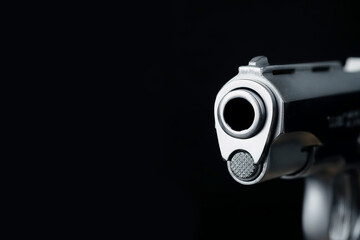 The muzzle part of the pistol scene on a black background represents a concept related to the...