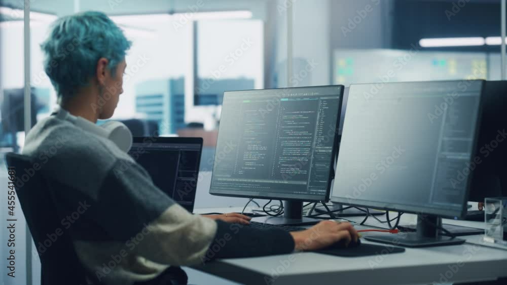 Poster In Diverse Office: Female Programmer is Working on Desktop Computer, Screen Shows Coding Language User Interface. Digital Entrepreneur Creating Modern Software, e-Commerce App Design. Over Shoulder